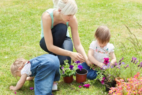 Kilburn gardeners shaping shrubs in a courtyard garden